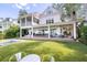 Expansive backyard with covered porch, outdoor seating, and a refreshing pool for relaxation and entertainment at 202 Bank St, Mount Pleasant, SC 29464