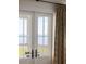 Balcony doors opening to a view of a grassy marsh with bay waters beyond at 202 Bank St, Mount Pleasant, SC 29464