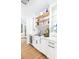 Chic bar area boasts white cabinetry, open shelving, and a black and white patterned backsplash at 202 Bank St, Mount Pleasant, SC 29464