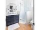Bathroom with navy blue vanity, glass-enclosed shower, and modern fixtures for a spa-like experience at 202 Bank St, Mount Pleasant, SC 29464