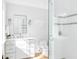 Clean, bright bathroom features a tiled shower, modern vanity, and minimalist design at 202 Bank St, Mount Pleasant, SC 29464