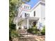 Charming front exterior of home with a brick staircase, white columns, and beautiful landscaping at 202 Bank St, Mount Pleasant, SC 29464