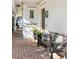 Charming front porch with brick flooring, welcome sign, seating, and plants near the water at 202 Bank St, Mount Pleasant, SC 29464