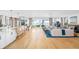 Spacious open-concept living room featuring a kitchen island and seating with beautiful hardwood floors at 202 Bank St, Mount Pleasant, SC 29464