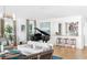 Elegant living room with a piano, sofa, bar area, modern lighting, and hardwood flooring at 202 Bank St, Mount Pleasant, SC 29464