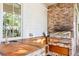 Outdoor kitchen area with a built-in grill, countertop space, sink, and brick accent wall at 202 Bank St, Mount Pleasant, SC 29464