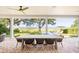 Covered outdoor patio with a dining table, lounge chairs, and views of the swimming pool and waterfront at 202 Bank St, Mount Pleasant, SC 29464