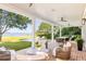 Covered patio featuring an outdoor seating area, dining table, and views of the pool, lawn, and waterfront at 202 Bank St, Mount Pleasant, SC 29464