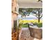Covered patio with a fireplace and comfortable seating, offering views of the yard and a waterway at 202 Bank St, Mount Pleasant, SC 29464