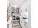 Walk-in pantry with built-in shelving, stainless steel appliances, and counter space for food preparation at 202 Bank St, Mount Pleasant, SC 29464