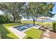 Backyard with a modern swimming pool, lounge chairs, mature trees, and a picturesque view of the waterway at 202 Bank St, Mount Pleasant, SC 29464