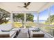 Relaxing screened porch featuring water views and comfortable lounge seating, perfect for enjoying the outdoors at 202 Bank St, Mount Pleasant, SC 29464