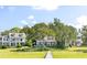 Charming waterfront homes with well-manicured lawns, a private dock, and scenic water views at 202 Bank St, Mount Pleasant, SC 29464