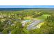 Scenic aerial shot displaying a community pool, tennis courts and lush green landscape at 203 Yeamans Way, Summerville, SC 29483