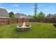 Spacious fenced backyard featuring a cozy fire pit at 203 Yeamans Way, Summerville, SC 29483