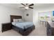 A cozy bedroom with a large bed, ceiling fan, and natural light offers a relaxing retreat at 203 Yeamans Way, Summerville, SC 29483