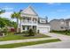 Inviting two-story home featuring a charming double porch, manicured lawn, and two-car garage at 203 Yeamans Way, Summerville, SC 29483
