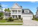 Charming two-story home featuring a double front porch, landscaped yard, and two-car garage at 203 Yeamans Way, Summerville, SC 29483