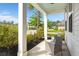 Relaxing front porch features comfortable seating, lush landscaping, and a serene street view at 203 Yeamans Way, Summerville, SC 29483