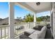 Inviting covered front porch with comfortable wicker furniture and ample seating for relaxation and enjoying the outdoors at 203 Yeamans Way, Summerville, SC 29483