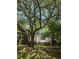 A charming single-story home is framed by large trees and lush greenery enhancing its natural beauty at 2041 Covey Ln, Charleston, SC 29412