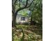 Backyard featuring mature trees providing ample shade, complemented by a fence and side yard access at 2041 Covey Ln, Charleston, SC 29412