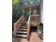 Newly constructed deck with wooden stairs and railings, offering a charming outdoor retreat at 2041 Covey Ln, Charleston, SC 29412