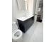 Bathroom with a dark vanity, white countertop, and marble floors for a clean, modern look at 208 Orange St, Walterboro, SC 29488
