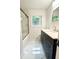 Modern bathroom featuring marble floors, dual sink vanity, and glass shower enclosure at 208 Orange St, Walterboro, SC 29488