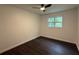 Cozy bedroom with hardwood floors and a ceiling fan, featuring ample natural light from the window at 208 Orange St, Walterboro, SC 29488