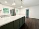 Bright open kitchen with a large island, stainless steel appliances, and modern pendant lighting at 208 Orange St, Walterboro, SC 29488
