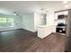 Open-concept living and kitchen area with modern appliances, stylish lighting, and hardwood floors at 208 Orange St, Walterboro, SC 29488