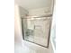 Close up on a tiled tub/shower combo with a modern glass sliding door and a built-in niche at 208 Orange St, Walterboro, SC 29488