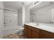 Well-lit bathroom featuring vanity and tub/shower combo with white tiled walls at 215 Jackson St, Goose Creek, SC 29445