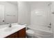 Clean bathroom with vanity and a tub/shower combo featuring white walls and a shower head at 215 Jackson St, Goose Creek, SC 29445
