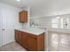Kitchen area with wooden cabinets and view of the bright living room at 215 Jackson St, Goose Creek, SC 29445