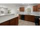 Modern kitchen with stainless steel appliances, wooden cabinets, and island with white countertops at 215 Jackson St, Goose Creek, SC 29445