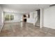 Spacious living room with tile floors open to kitchen and stairs. Light filled and neutral paint colors at 215 Jackson St, Goose Creek, SC 29445