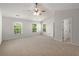 Spacious main bedroom with vaulted ceilings, neutral carpet, ceiling fan, and ensuite bathroom at 215 Jackson St, Goose Creek, SC 29445