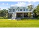 Back of house with spacious lawn, patio, and elevated deck at 2363 Palmer Creek Bnd, Charleston, SC 29412