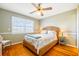 Bright bedroom with ceiling fan, wood floors, and a woven headboard at 2363 Palmer Creek Bnd, Charleston, SC 29412