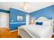 Bedroom featuring a white bed frame, blue walls, and hardwood floors at 2363 Palmer Creek Bnd, Charleston, SC 29412