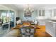 A dining room features a wooden table, upholstered chairs, and a sliding glass door at 2363 Palmer Creek Bnd, Charleston, SC 29412