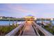 Twilight scene of a private boat dock featuring a gazebo with lighting, alongside calm waters at 2363 Palmer Creek Bnd, Charleston, SC 29412
