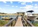 Picturesque boat dock featuring a boat lift, gazebo with seating, and a walkway extending over calm waters at 2363 Palmer Creek Bnd, Charleston, SC 29412