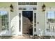 Elegant front door with glass accents and lantern sconces at 2363 Palmer Creek Bnd, Charleston, SC 29412