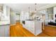 Bright kitchen features white cabinets, island with granite countertops, and hardwood floors at 2363 Palmer Creek Bnd, Charleston, SC 29412
