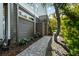 Charming side yard with a stone walkway lined with beautiful flowers and lush landscaping at 2363 Palmer Creek Bnd, Charleston, SC 29412