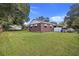 Large backyard with lush green grass and mature trees at 2703 Phyllis St, North Charleston, SC 29405