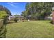 Expansive backyard featuring lush green grass and mature trees with plenty of space at 2703 Phyllis St, North Charleston, SC 29405